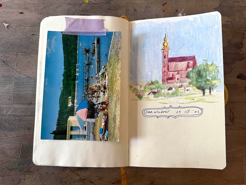 picture of an open sketchbook with sketch of landscape